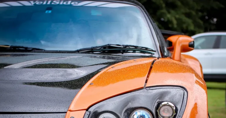 The left front of the orange black veilside mazda Rx-7