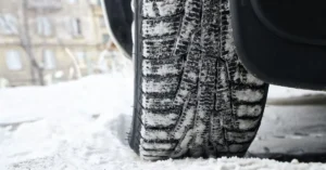 Snowtire on a road which is covered in snow.