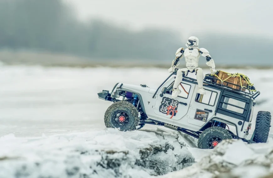 A RC Car on snowy ground with a Star Wars Trooper on the back
