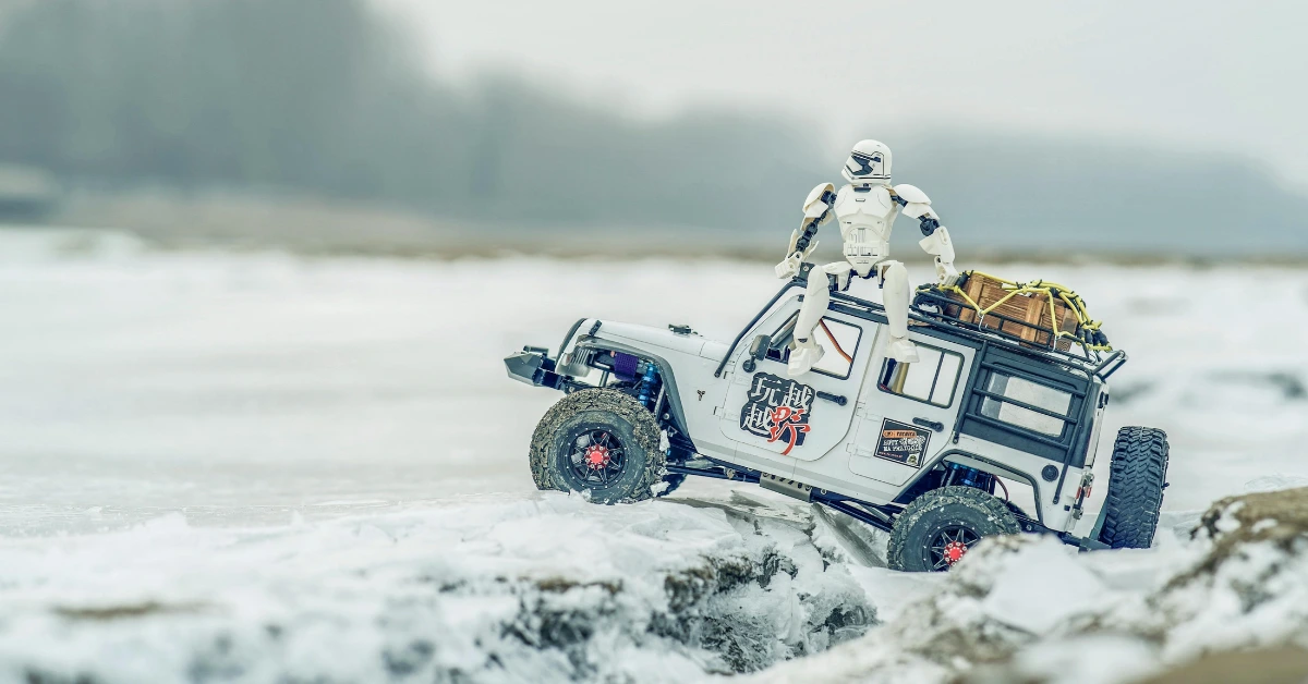 A RC Car on snowy ground with a Star Wars Trooper on the back