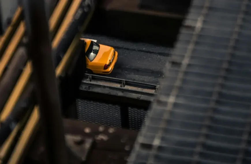 A cab is standing under a bridge
