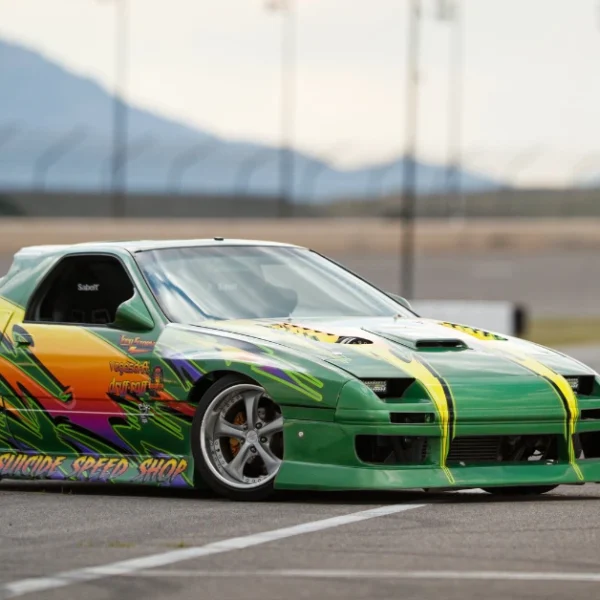 A green Airbrushed Nissan SX240 drifting