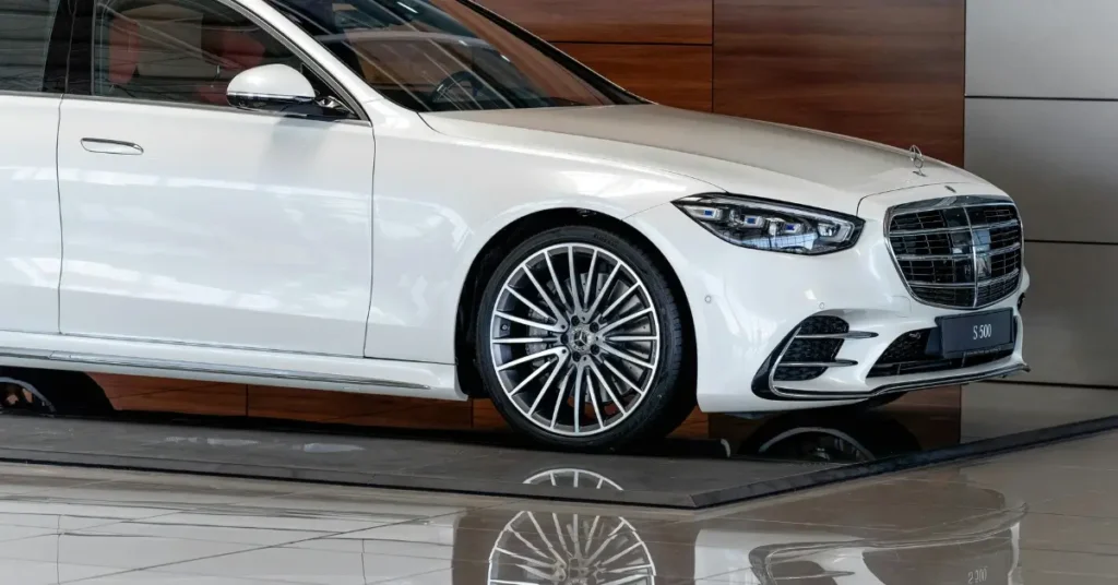 A white Mercedes S 500 in a showroom