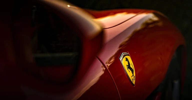 A close up photography from the Logo of a red Ferrari
