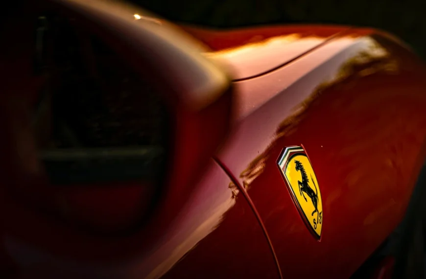 A close up photography from the Logo of a red Ferrari