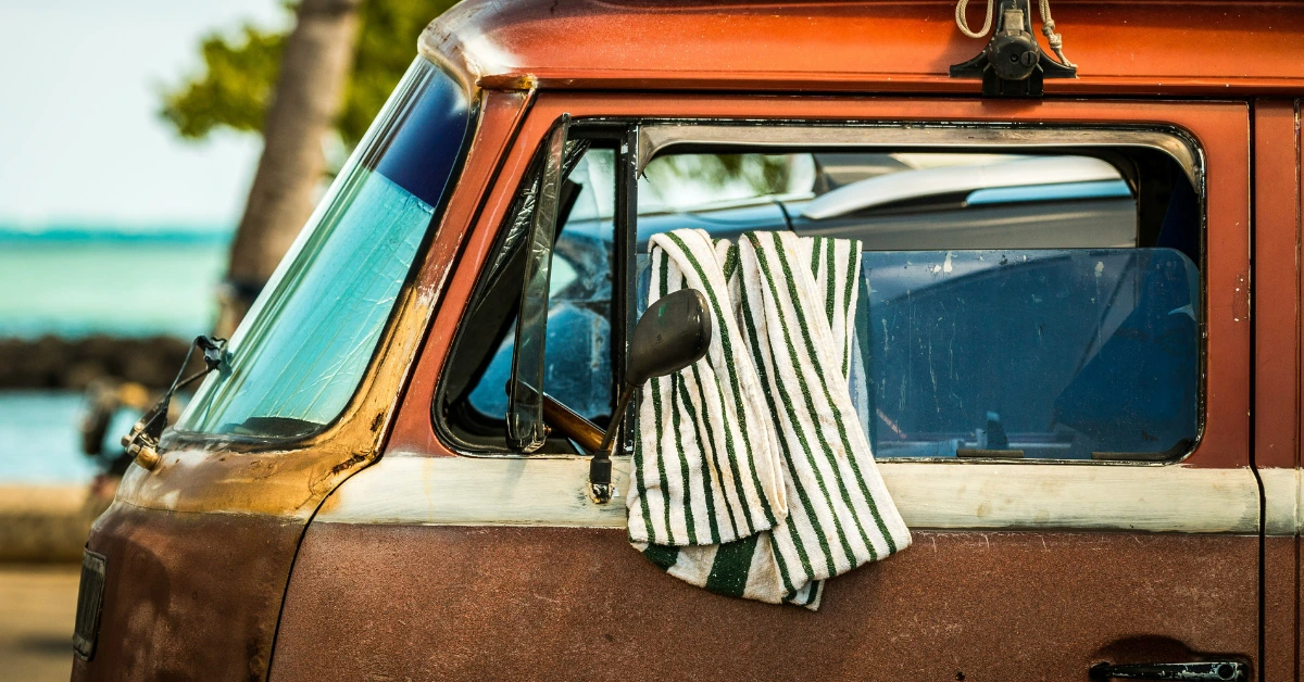 Towel hanging over the drivers window of a VW Bus