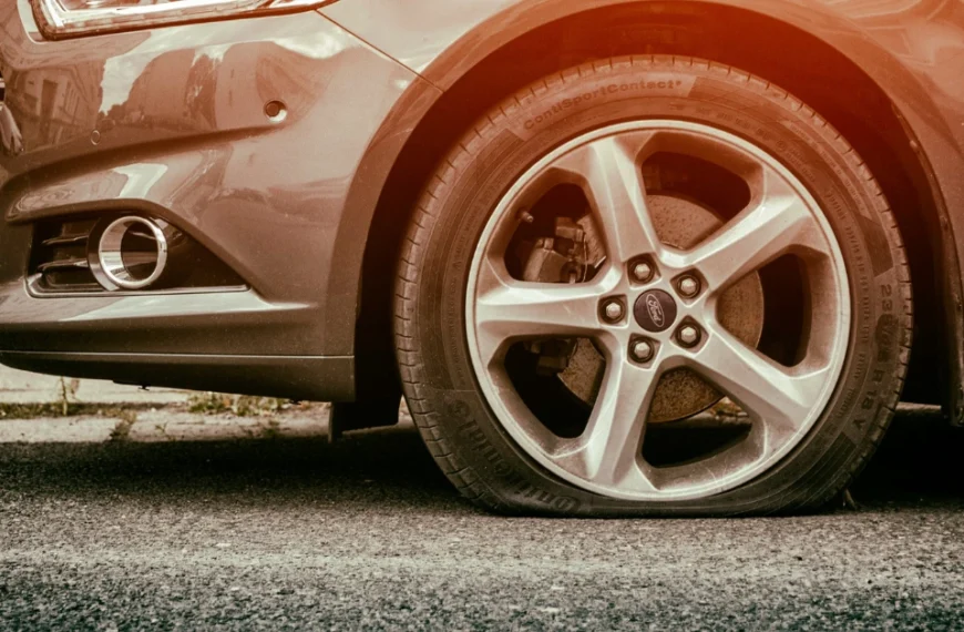 A flat Tire front left on a parked car