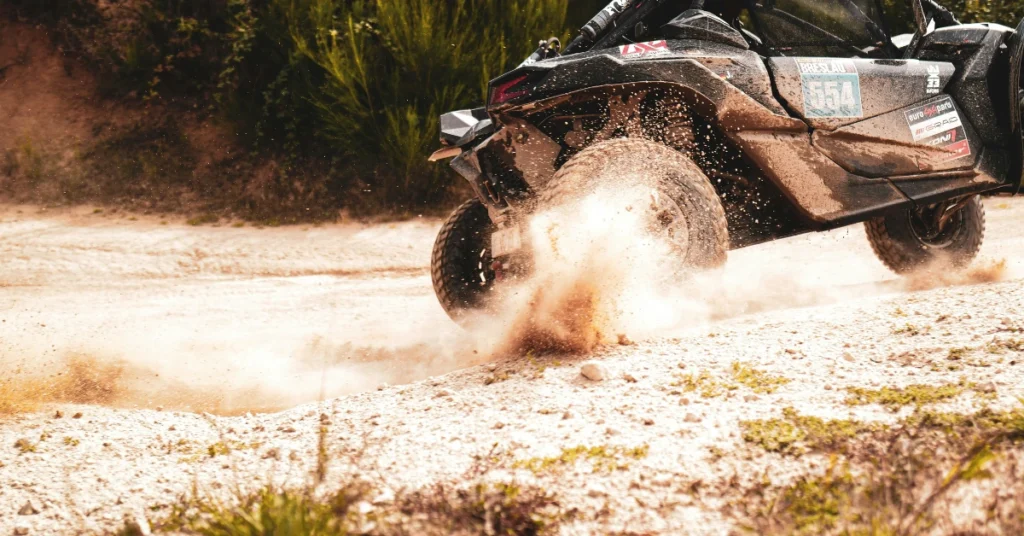 A Rally car with Rally tires driving throught sand