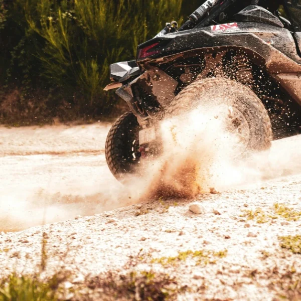 A Rally car with Rally tires driving throught sand