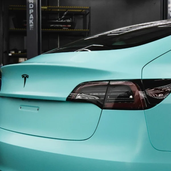 A Tesla wrapped in mint green