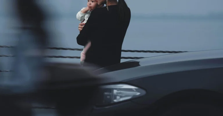 A Mother and her child behind a Sedan