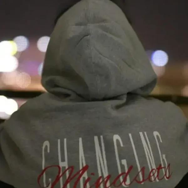 A guy with a grey Hoddie with the writing "Changing Mindsets"