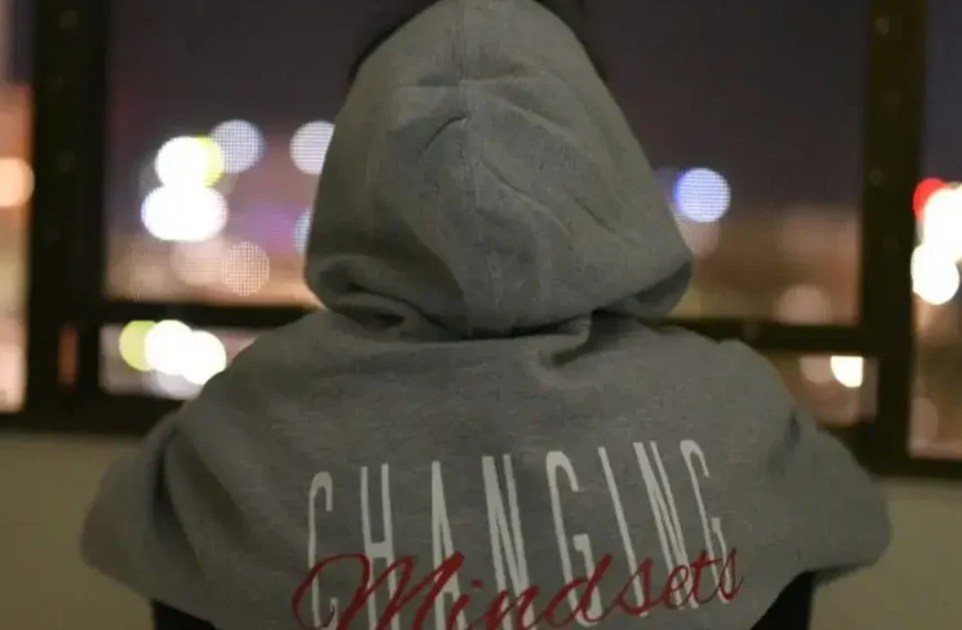 A guy with a grey Hoddie with the writing "Changing Mindsets"