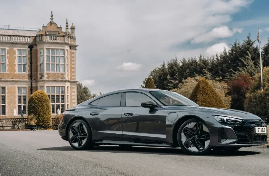 Grey Audi RS e-Tron GT in front of a Castle