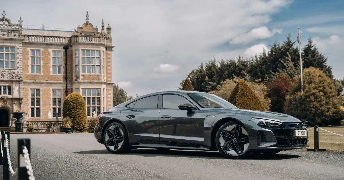 Grey Audi RS e-Tron GT in front of a Castle