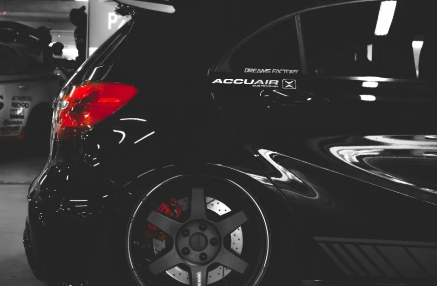 The side of Black tuned car with graphite colored rims