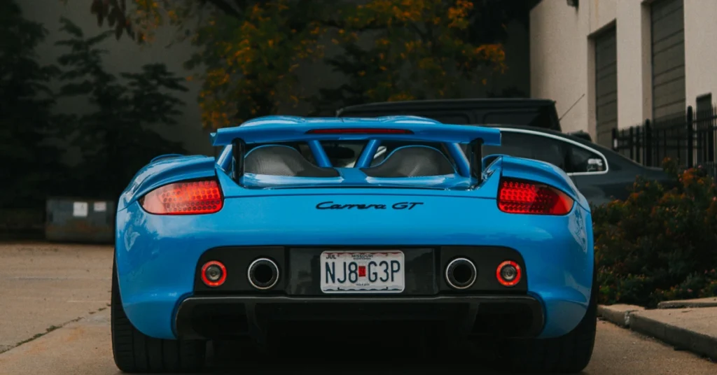 The back of a babyblue Porsche Carrera GT