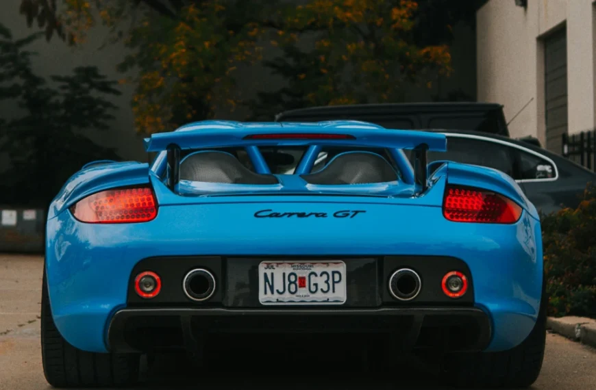 The back of a babyblue Porsche Carrera GT