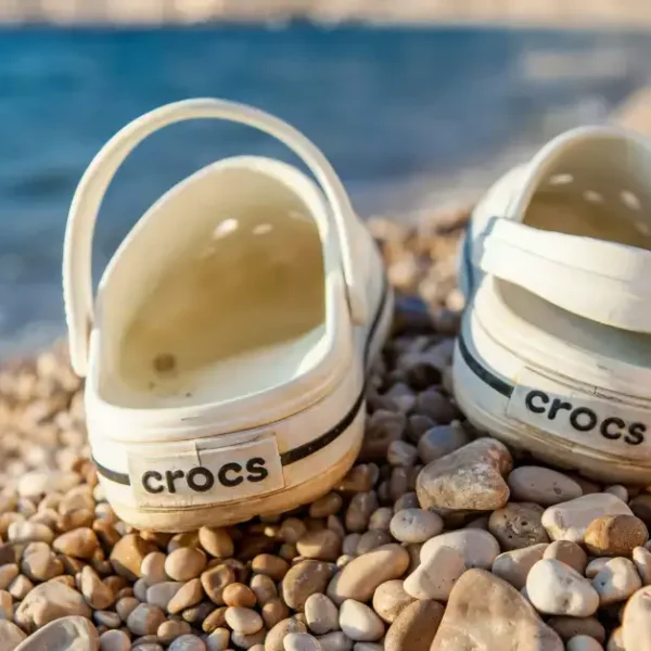 Two white Crocs standing on a Sandbeach