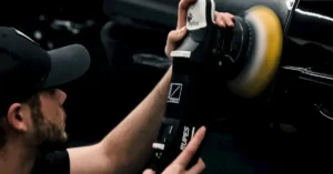 A Man polishing a Car with a Car Polisher