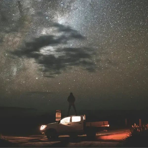 A SUV with a Tent in Front of a big Starsky